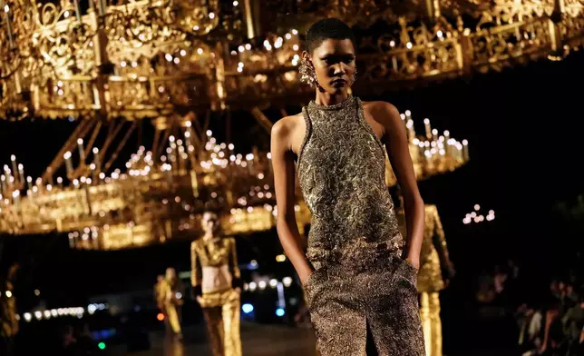 A model wears a creation as part of the Saint Laurent Womenswear Spring Summer 2027 collection presented in Paris, France, Tuesday, Sept. 29, 2026. (AP Photo/Teresa Suarez)