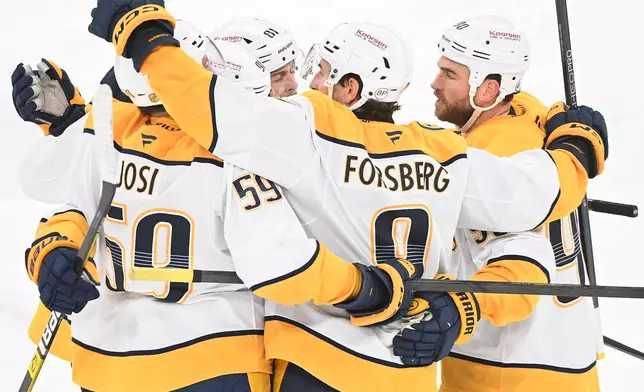 Nashville Predators' Ryan O'Reilly, right, celebrates with teammates after scoring against the Montreal Canadiens during the third period of an NHL hockey game in Montreal, Thursday, Oct. 8, 2026. (Graham Hughes/The Canadian Press via AP)