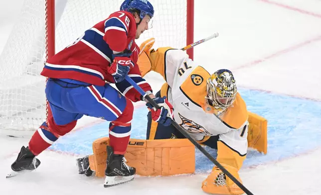 Nashville Predators goaltender Juuse Saros, right, stops Montreal Canadiens' Zachary Bolduc (76) during the first period of an NHL hockey game in Montreal, Thursday, Oct. 8, 2026. (Graham Hughes/The Canadian Press via AP)