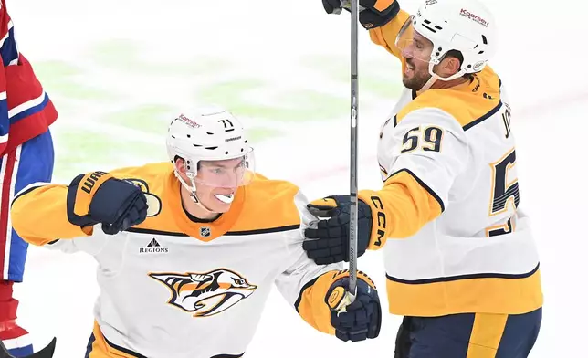 Nashville Predators' Matthew Wood (71) celebrates with teammate Roman Josi (59) after scoring against the Montreal Canadiens during the second period of an NHL hockey game in Montreal, Thursday, Oct. 8, 2026. (Graham Hughes/The Canadian Press via AP)
