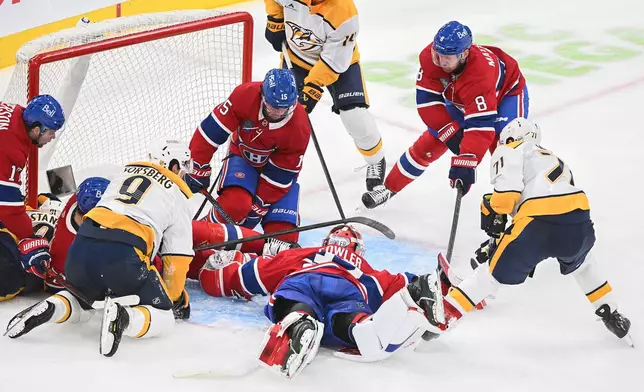 Nashville Predators' Matthew Wood (71) moves in to score against Montreal Canadiens goaltender Jacob Fowler, center bottom, during the second period of an NHL hockey game in Montreal, Thursday, Oct. 8, 2026. (Graham Hughes/The Canadian Press via AP)