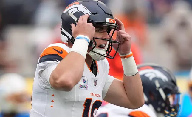 Denver Broncos quarterback Bo Nix gestures before taking a snap during the first half of an NFL football game against the Los Angeles Chargers, Sunday, Oct. 11, 2026, in Inglewood, Calif. (AP Photo/Scott Strazzante)