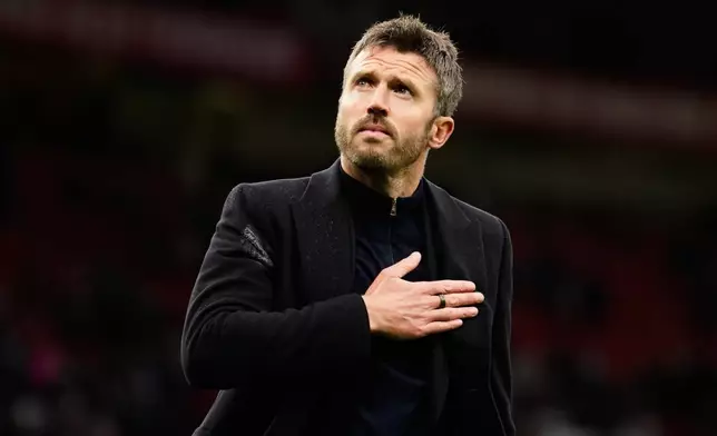 Manchester United's head coach Michael Carrick reacts to supporters after his team lost the English Premier League soccer match between Manchester United and Bournemouth in Manchester, England, Sunday, Oct. 25, 2026. (AP Photo/Dave Thompson)