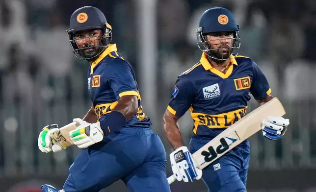 Sri Lanka's Janith Liyanage, left, and Pavan Rathnayake run between the wickets during the tri-series one-day international cricket match between Pakistan and Sri Lanka, in Rawalpindi, Pakistan, Sunday, Oct. 18, 2026. (AP Photo/Anjum Naveed)