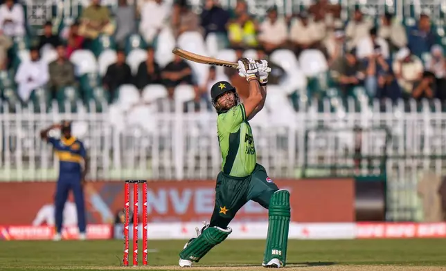 Pakistan's Salman Ali Agha follows the ball after playing a shot for boundary during the tri-series one-day international cricket match between Pakistan and Sri Lanka, in Rawalpindi, Pakistan, Sunday, Oct. 18, 2026. (AP Photo/Anjum Naveed)