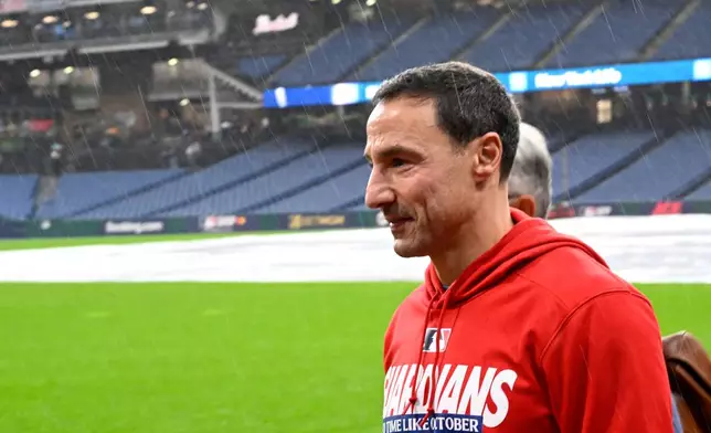 Cleveland Guardians is Chris Antonetti, walks on the field in the rain before Game 4 of an American League Championship Series baseball game against the Tampa Bay Rays in Cleveland, Friday, Oct. 16, 2026. (AP Photo/Phil Long)