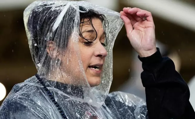 Chrissy Calabrese waits for the start of Game 4 of an American League Championship Series baseball game between the Cleveland Guardians and the Tampa Bay Rays in Cleveland, Friday, Oct. 16, 2026. (AP Photo/David J. Phillip)