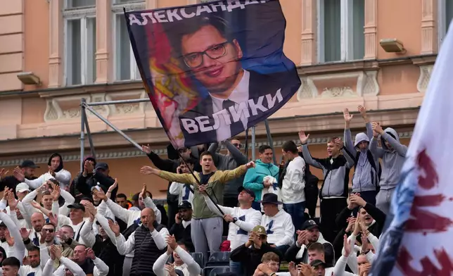 Supporters wave a flag shows Serbia's populist leader Aleksandar Vucic during a pre-election rally of the ruling Serbian Progressive Party (SNS) ahead of early parliamentary elections in Novi Sad, Serbia, Friday, Oct. 16, 2026. (AP Photo/Darko Vojinovic)