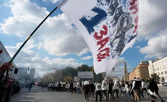 Supporters of Serbia's populist leader Aleksandar Vucic gather prior a pre-election rally of the ruling Serbian Progressive Party (SNS) ahead of early parliamentary elections in Novi Sad, Serbia, Friday, Oct. 16, 2026. (AP Photo/Darko Vojinovic)