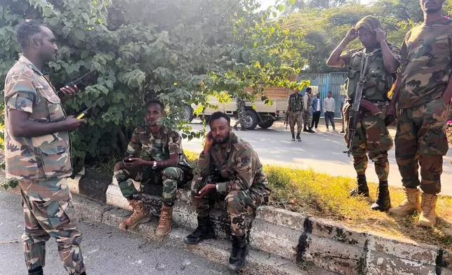 Tigray Peace Force fighters stand in a road after entering Mekelle, in Ethiopia's Tigray region, Sunday, Oct. 4, 2026. (AP Photo/Filmon Equar Hailu)