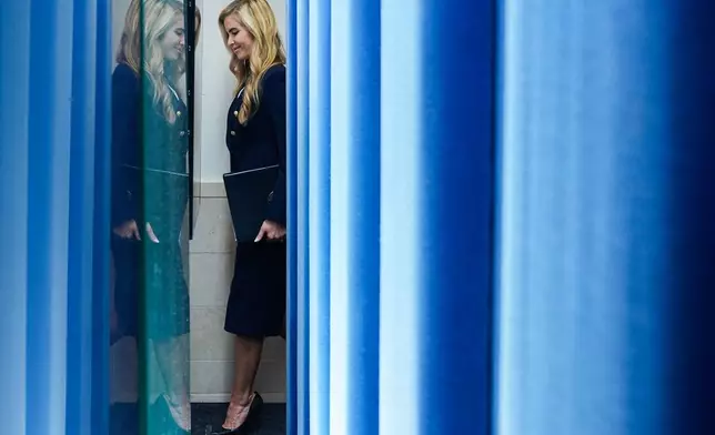 White House press secretary Katie Zacharia arrives in the James Brady Press Briefing Room at the White House, Tuesday, Oct. 13, 2026, in Washington. (AP Photo/Julia Demaree Nikhinson)