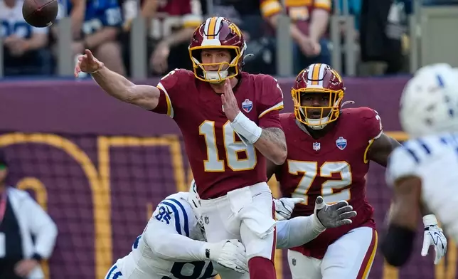Washington Commanders quarterback Athan Kaliakmanis (16) throws a pass challenged vy Indianapolis Colts defensive tackle Adetomiwa Adebawore (95) during an NFL football game against Indianapolis Colts in London, Sunday, Oct. 4, 2026. (AP Photo/David J. Phillip)