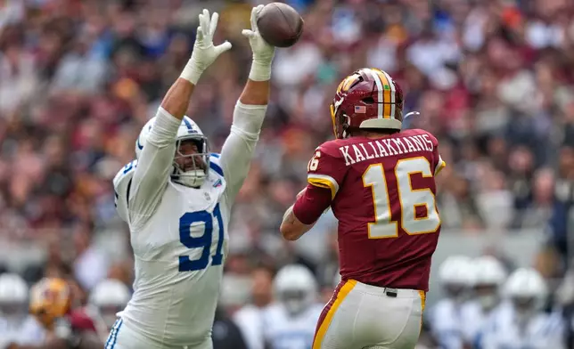 Indianapolis Colts defensive end Jaylahn Tuimoloau (91) tries to block a pass by Washington Commanders quarterback Athan Kaliakmanis (16) during an NFL football game in London, Sunday, Oct. 4, 2026. (AP Photo/David J. Phillip)