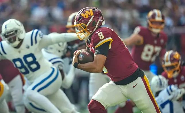 Washington Commanders quarterback Marcus Mariota (8) runs with the ball during an NFL football game against Indianapolis Colts in London, Sunday, Oct. 4, 2026. (AP Photo/David J. Phillip)