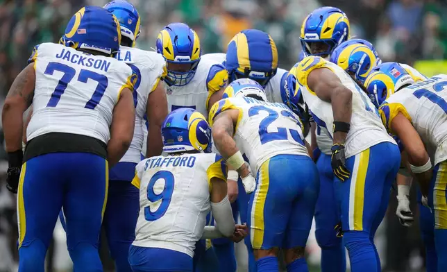 Los Angeles Rams quarterback Matthew Stafford (9) speaks with teammates in a huddle during the second half of an NFL football game against the Philadelphia Eagles in Philadelphia, Sunday, Oct. 4, 2026. (AP Photo/Matt Slocum)
