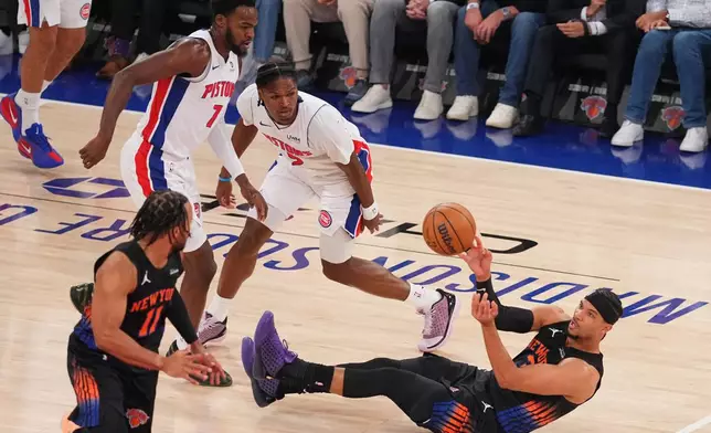New York Knicks' Josh Hart (3) passes the ball awat from Detroit Pistons' Ronald Holland II (5) and Paul Reed (7) to teammate Jalen Brunson (11) during the first half of an NBA basketball game Tuesday, Oct. 27, 2026, in New York. (AP Photo/Frank Franklin II)