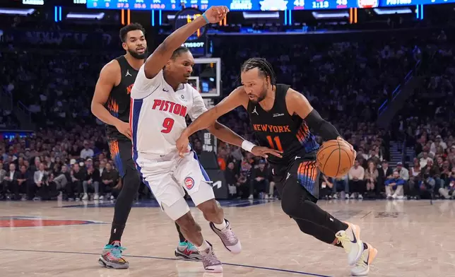 Detroit Pistons' Ausar Thompson (9) defends New York Knicks' Jalen Brunson (11) during the first half of an NBA basketball game Tuesday, Oct. 27, 2026, in New York. (AP Photo/Frank Franklin II)
