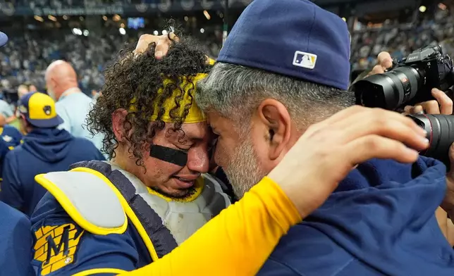 Milwaukee Brewers catcher William Contreras celebrates with manager Pat Murphy after their win against the Tampa Bay Rays in baseball's World Series, Wednesday, Oct. 28, 2026, in St. Petersburg, Fla. (AP Photo/Ashley Landis)