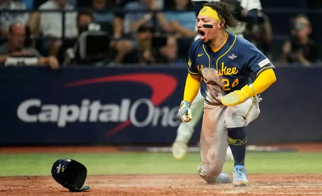 Milwaukee Brewers' William Contreras celebrates after scoring during the sixth inning of Game 5 of baseball's World Series, Wednesday, Oct. 28, 2026, in St. Petersburg, Fla., between the Milwaukee Brewers and the Tampa Bay Rays. (AP Photo/Ashley Landis)
