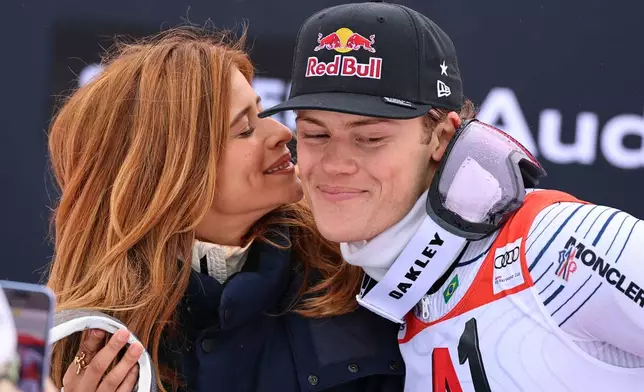 Brazil's Lucas Pinheiro Braathen, right, winner of an alpine ski, men's World Cup giant slalom, celebrates with his partner Isadora Cruz, in Soelden, Austria, Sunday, Oct. 25, 2026. (AP Photo/Marco Trovati) CORRECTION: Spelling corrected to Isadora instead of Isidora