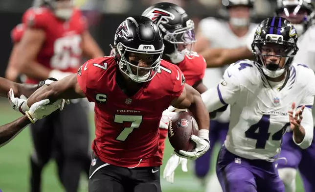 Atlanta Falcons running back Bijan Robinson (7) runs from Baltimore Ravens cornerback Marlon Humphrey (44) during the second half of an NFL football game, Sunday, Oct. 11, 2026, in Atlanta. (AP Photo/Mike Stewart)