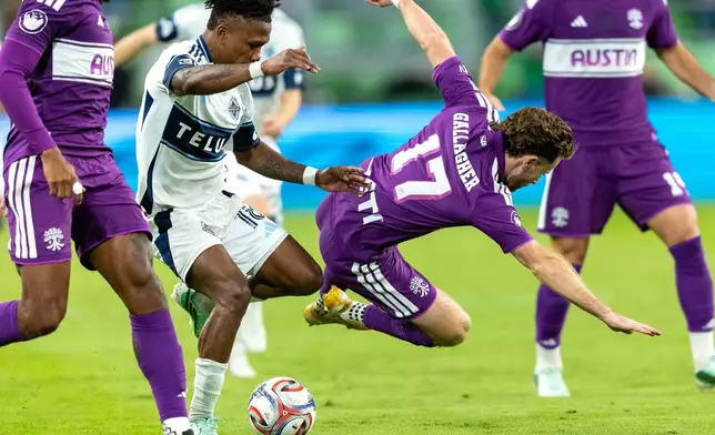 Vancouver Whitecaps defender Édier Ocampo (18) takes possession away from Austin FC defender Jon Gallagher (17) during the second half of an MLS soccer match in Austin, Texas, Saturday, Oct. 17, 2026. (AP Photo/Stephen Spillman)