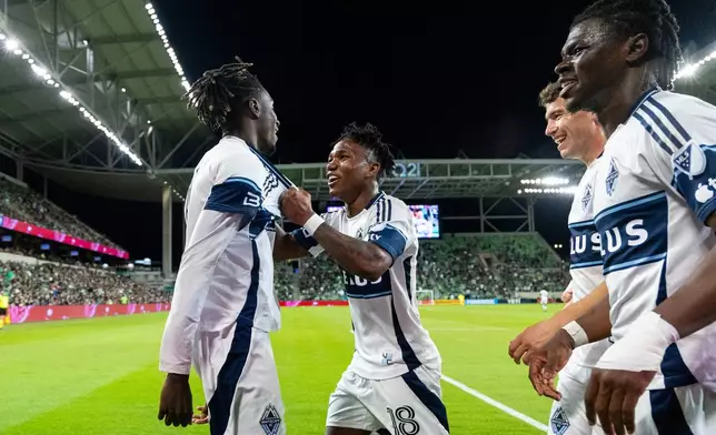 Vancouver Whitecaps forward Yadaly Diaby, left, celebrates his goal against Austin FC with defender Édier Ocampo (18), midfielder Aleksa Cvetković and forward Emmanuel Sabbi during the second half of an MLS soccer match in Austin, Texas, Saturday, Oct. 17, 2026. (AP Photo/Stephen Spillman)