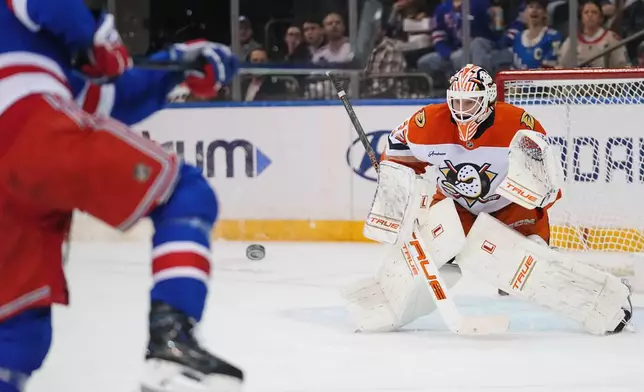 Anaheim Ducks goaltender Ville Husso, right, protects the net from New York Rangers' Gabe Perreault, left, during the first period of an NHL hockey game Monday, Oct. 19, 2026, in New York. (AP Photo/Frank Franklin II)