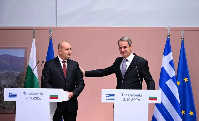 Greece's Prime Minister Kyriakos Mitsotakis, right, and Bulgarian counterpart Rumen Radev, attend a handover ceremony of the remains of medieval ruler Czar Samuel, in Thessaloniki, northern Greece, Saturday, Oct. 3, 2026. (AP Photo/Giannis Papanikos)