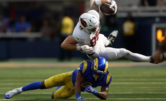 Arizona Cardinals tight end Trey McBride, top, is tackled by Los Angeles Rams safety Jaylen McCollough during the second half of an NFL football game in Inglewood, Calif., Sunday, Oct. 18, 2026. (AP Photo/Caroline Brehman)