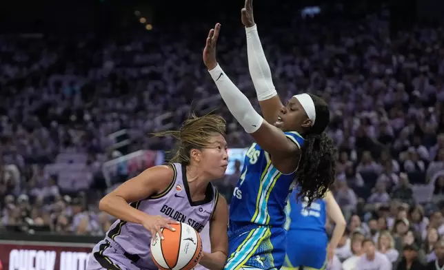 Golden State Valkyries guard Kaitlyn Chen, left, drives to the basket against Dallas Wings guard Arike Ogunbowale during the first half of Game 3 of a WNBA basketball first-round playoff series, Friday, Oct. 2, 2026, in San Francisco. (AP Photo/Jeff Chiu)