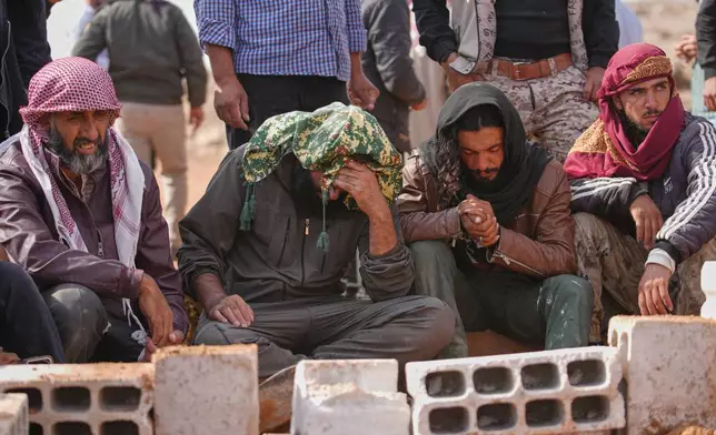 Mourners pray during the funeral of five members of the same family, including three children, killed in a Jordanian airstrike, which Jordan acknowledged had killed civilians, in Al-Tuff in southern Syria's Daraa province, Tuesday, Oct. 27, 2026. (AP Photo/Ghaith Alsayed)