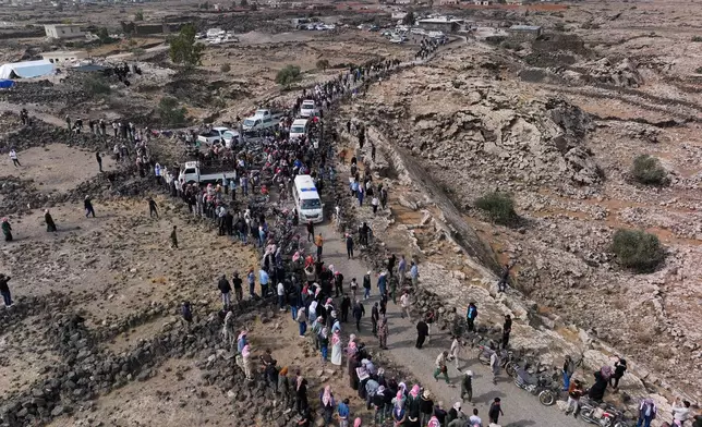 Mourners join the funeral procession for five family members, including three children, killed in a Jordanian airstrike in Al-Tuff in southern Syria's Daraa province, Tuesday, Oct. 27, 2026, following attacks Jordan said targeted Islamic State militants and acknowledged also killed civilians. (AP Photo/Ghaith Alsayed)