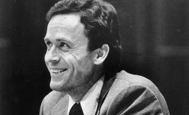 FILE - Ted Bundy smiles during the second day of jury selection for his murder trial in a Dade County courtroom in Miami, June 27, 1979. (AP Photo, Pool, File)