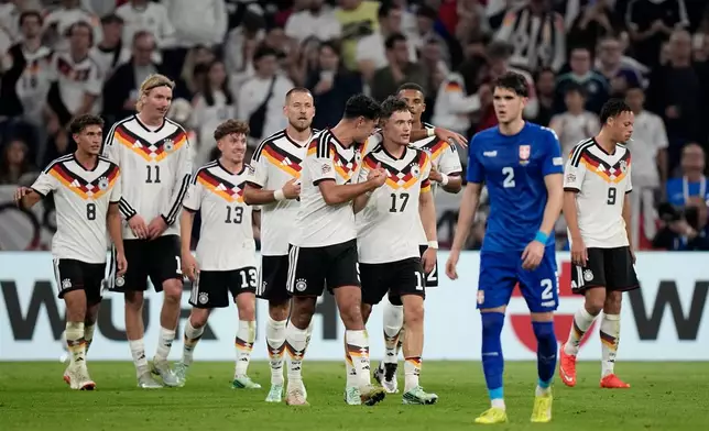 Germany's Florian Wirtz celebrates with teammates after scoring his side's second goal during the UEFA Nations League soccer match between Germany and Serbia in Munich, Germany, Thursday, Oct. 1, 2026. (AP Photo/Matthias Schrader)