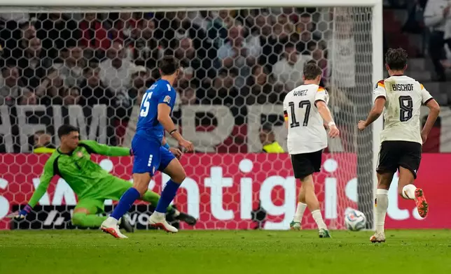 Germany's Florian Wirtz, second right, scores his side's second goal during the UEFA Nations League soccer match between Germany and Serbia in Munich, Germany, Thursday, Oct. 1, 2026. (AP Photo/Matthias Schrader)