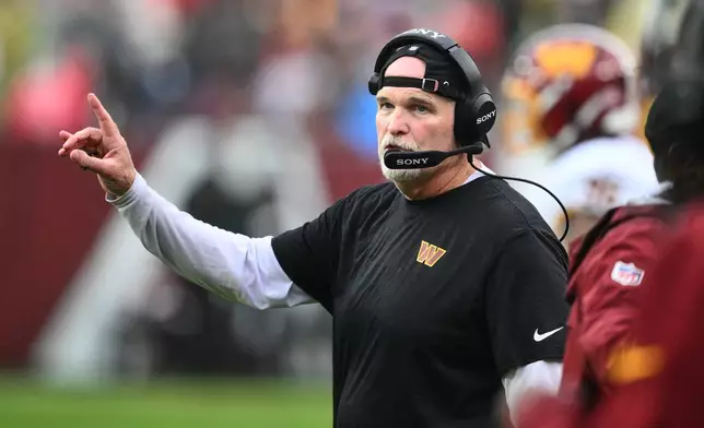 Washington Commanders head coach Dan Quinn gestures while talking to his team during the second half of an NFL football game against the New York Giants in Landover, Md., Sunday, Oct. 11, 2026. (AP Photo/Nick Wass)