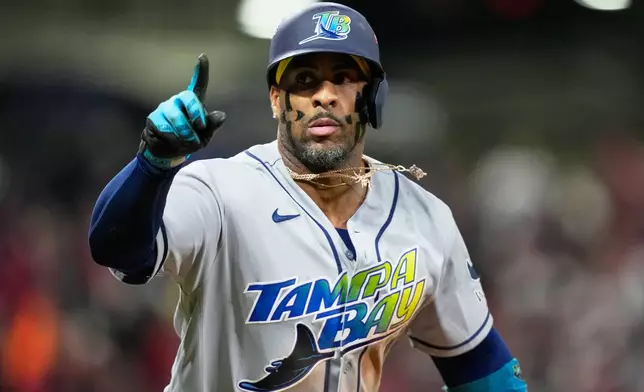 Tampa Bay Rays' Yandy Díaz celebrates a two-run home run against the Cleveland Guardians during the ninth inning in Game 4 of an American League Championship Series baseball game in Cleveland, Saturday, Oct. 17, 2026. (AP Photo/David J. Phillip)