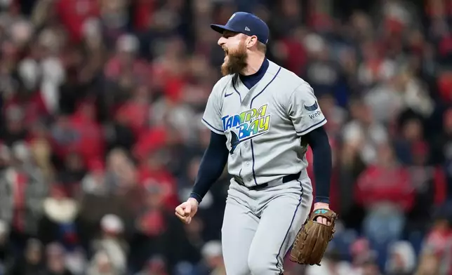 Tampa Bay Rays pitcher Bryan Baker celebrates their win against the Cleveland Guardians in Game 4 of an American League Championship Series baseball game in Cleveland, Saturday, Oct. 17, 2026. (AP Photo/David J. Phillip)
