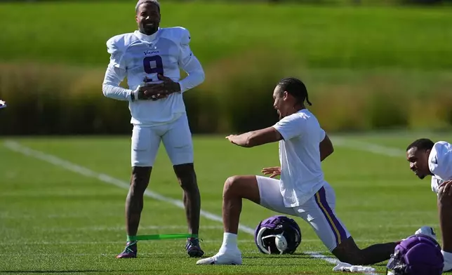 Minnesota Vikings wide receivers Odell Beckham Jr., left, and Justin Jefferson, right, stretch during an NFL football practice Wednesday, Oct. 7, 2026, in Eagan, Minn. (AP Photo/Abbie Parr)