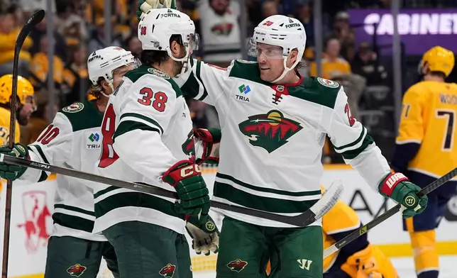 Minnesota Wild left wing Blake Coleman (20) celebrates his goal with right wing Ryan Hartman (38) during the first period of an NHL hockey game Thursday, Oct. 1, 2026, in Nashville, Tenn. (AP Photo/George Walker IV)