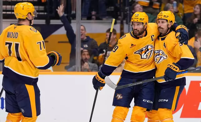 Nashville Predators defenseman Roman Josi (59) celebrates his goal with left wing Filip Forsberg (9) and right wing Matthew Wood (71) during the second period of an NHL hockey game against the Minnesota Wild, Thursday, Oct. 1, 2026, in Nashville, Tenn. (AP Photo/George Walker IV)