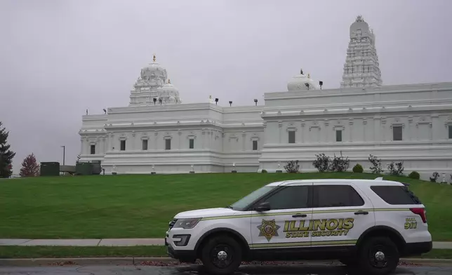 A security vehicle is parked outside of Sri Venkateswara Swami (Balaji) Temple in Aurora, Ill., Thursday, Oct. 15, 2026. (AP Photo/Laura Bargfeld)