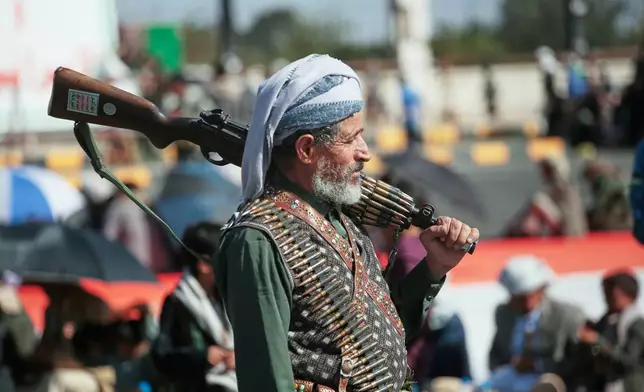A supporter of Yemen's Houthi rebels carries his rifle during a rally in support of the group in Sanaa, Yemen, Friday, Oct. 9, 2026. (AP Photo/Osamah Abdulrahman)