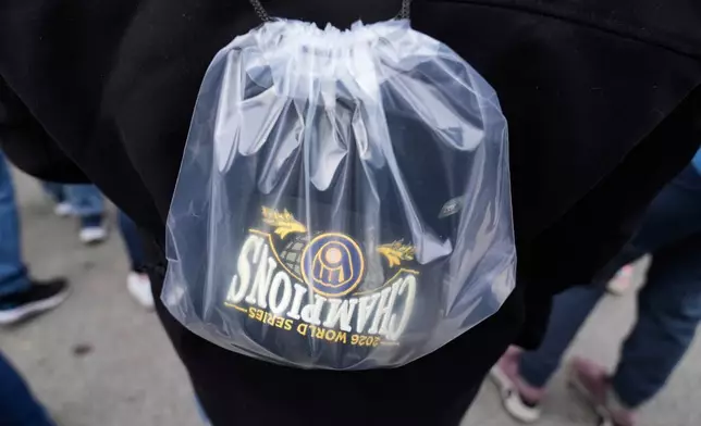 A fan arrives with a Milwaukee Brewers' Champions hat during the baseball team's World Series parade, Friday, Oct. 30, 2026, in Milwaukee. (AP Photo/Nam Huh)