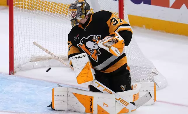 The winning goal by Utah Mammoth's Mikhail Sergachev (not shown) gets behind Pittsburgh Penguins goaltender Arturs Silovs during the overtime period of an NHL hockey game in Pittsburgh, Thursday, Oct. 29, 2026. (AP Photo/Gene J. Puskar)