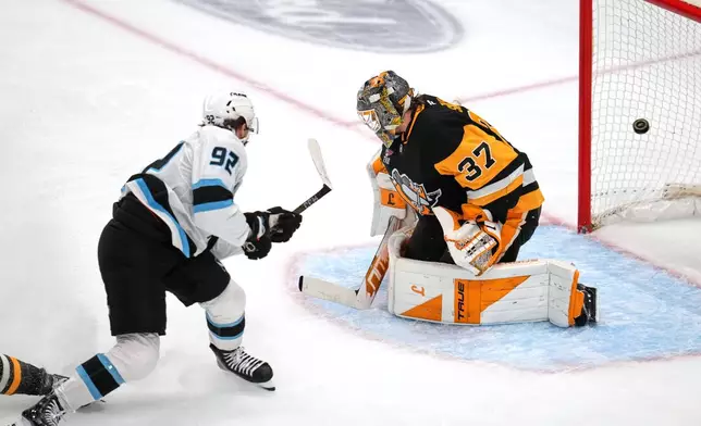 Utah Mammoth's Logan Cooley (92) gets a shot behind Pittsburgh Penguins goaltender Arturs Silovs (37) for his second goal of the first period during an NHL hockey game in Pittsburgh, Thursday, Oct. 29, 2026. (AP Photo/Gene J. Puskar)