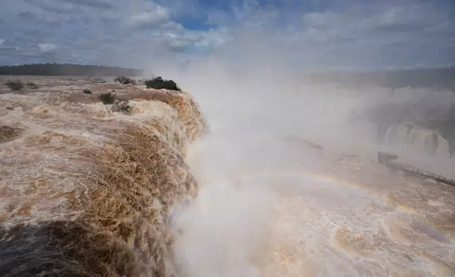 Water cascades over the cliffs of Iguazu Falls in Foz do Iguacu, Brazil, Friday, Oct. 16, 2026. (AP Photo/Jorge Saenz)