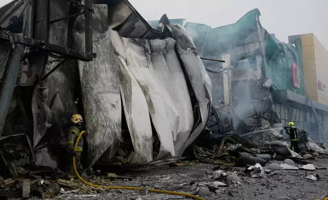 Firefighters try to extinguish a fire after a Russian missile attack in central Kyiv, Ukraine, Thursday, Oct. 22, 2026. (AP Photo/Efrem Lukatsky)