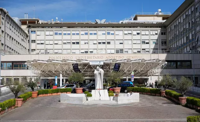 The statue of late pope St. John Paul II, center, is pictured at the Agostino Gemelli Polyclinic in Rome, Sunday, Oct. 11, 2026. (AP Photo/Gregorio Borgia)